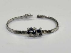 An 18ct white gold sapphire and diamond bracelet, approximately 1ct of diamonds, length 17.5cm.