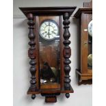 An early twentieth century mahogany eight day wall clock with brass and enamelled dial