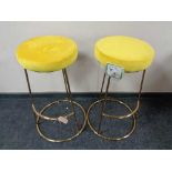 A pair of contemporary bar stools on metal bases