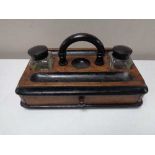 An Edwardian desk stand fitted a drawer and two glass ink wells