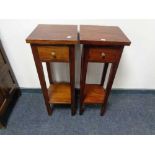 A pair of reproduction mahogany two tier plant stands fitted a drawer