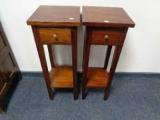 A pair of reproduction mahogany two tier plant stands fitted a drawer