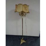 A continental brass standard lamp with shade