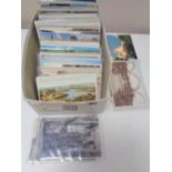 A box of early twentieth century and later colour and black and white postcards