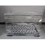 A folding black metal dog cage, height 52 cm, width 82 cm, depth 50 cm.