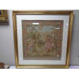 A gilt framed tapestry depicting figures in a garden