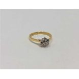 An 18ct gold seven stone diamond cluster ring, size K CONDITION REPORT: 2.