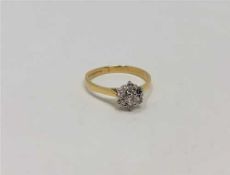 An 18ct gold seven stone diamond cluster ring, size K CONDITION REPORT: 2.
