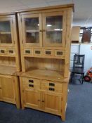 A contemporary oak kitchen dresser fitted with four drawers and double door cupboard beneath