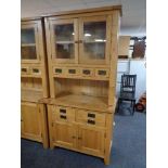 A contemporary oak kitchen dresser fitted with four drawers and double door cupboard beneath