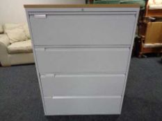 A four drawer metal document cabinet with oak effect top with key