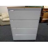 A four drawer metal document cabinet with oak effect top with key