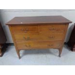 An Edwardian inlaid mahogany four drawer chest. Height 86 cm x length 108 cm x width 50 cm.