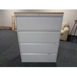 A four drawer metal document cabinet with oak effect top with key