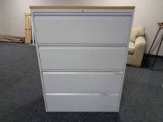 A four drawer metal document cabinet with oak effect top with key