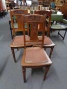 A set of three early 20th century carved oak dining chairs