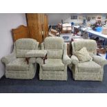 A pair of armchairs together with an electric reclining armchair in floral print together with