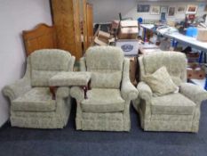 A pair of armchairs together with an electric reclining armchair in floral print together with