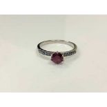 A silver synthetic ruby dress ring,