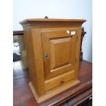 An early twentieth century wall cabinet fitted with a drawer