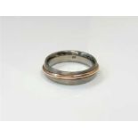 A gent's titanium and rose gold band ring,