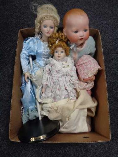 A box of four early twentieth century and later dolls