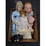 A box of four early twentieth century and later dolls
