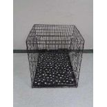 A folding black metal dog cage, height 70 cm, width 68 cm, depth 84 cm.