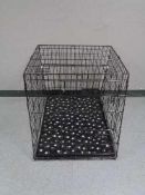 A folding black metal dog cage, height 70 cm, width 68 cm, depth 84 cm.