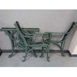 Two pairs of cast iron bench ends together with a pair of cast iron table ends