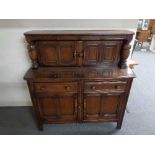 An Ercol buffett backed sideboard 124 cm wide, 125 cm height and 48 cm depth.