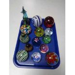 A tray of glass paperweights,