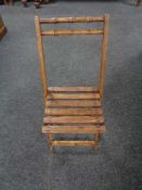 A twentieth century folding wooden child's chair