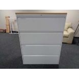 A four drawer metal document cabinet with oak effect top with key