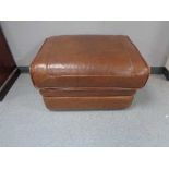 A tan leather footstool