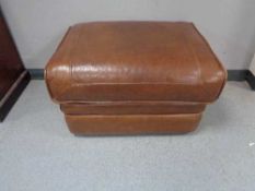 A tan leather footstool