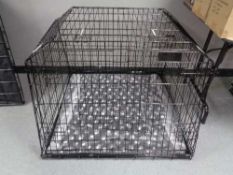 A folding black metal dog cage, height 74 cm, width 98 cm, depth 96 cm.