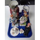A tray of continental figurines, Toby jug, pottery figure,