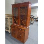 A yewwood double door bookcase top and inlaid mahogany double door cabinet