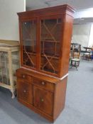 A yewwood double door bookcase top and inlaid mahogany double door cabinet