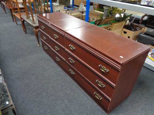 A mahogany effect three drawer chest together with a pair of three drawer bedside chests