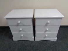 A pair of painted pine three drawer bedside chests