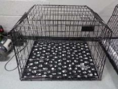 A folding black metal dog cage, height 67 cm, width 94 cm, depth 78 cm.