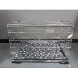 A folding black metal dog cage, height 52 cm, width 82 cm, depth 50 cm.