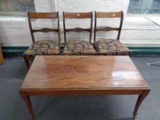 A set of three inlaid mahogany dining chairs together with a mahogany coffee table