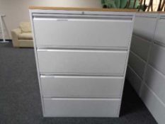 A four drawer metal document cabinet with oak effect top with key