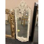 A cream fancy framed mirror