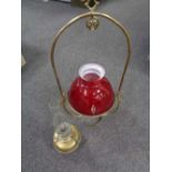 A brass Art Nouveau hanging oil lamp with glass shade and chimney