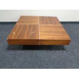 A contemporary square low coffee table in walnut finish