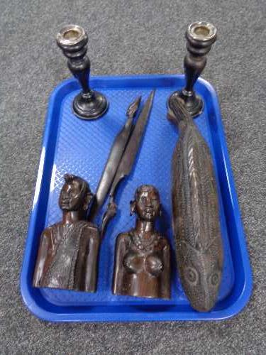 A tray of pair of ebony candlesticks with silver mounts, carved wooden fish box, two tribal busts,